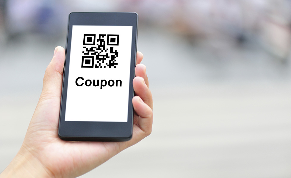 hand holding smart phone show a coupon code